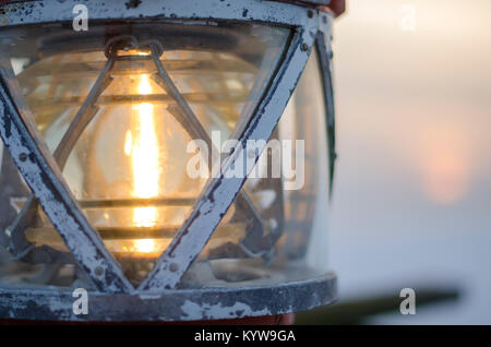 Lighthouse on the beach. Light for sailors. Lamp on the lighthouse Stock Photo
