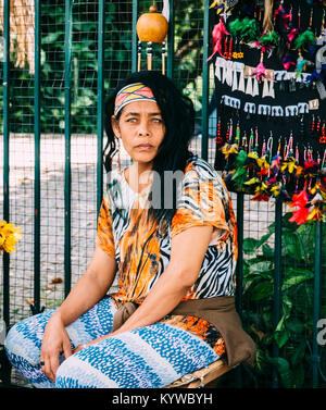 Worried stare of mixed race Brazilian indigenous woman selling goods at a street market in Belo Horizonte, Minas Gerais, Brazil Stock Photo