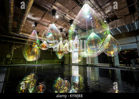 London, UK. 16th Jan, 2018. ‘Reflecting Holons' by Jetske Visser and Michiel Martens. Long strips of oil like transparent foil combined with simple spinning motors become a visual entity reflecting the lights around them as if they were water drops. As part of the Winter Lights interactive art installations at Canary Wharf Credit: Guy Corbishley/Alamy Live News Stock Photo