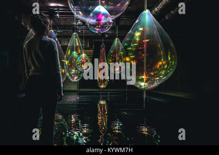 London, UK. 15th Jan, 2018. Winter Lights Festival in Canary Wharf 2018 - REFLECTING HOLONS, MICHIEL MARTENS & JETSKE VISSER - Experimenting with the ephemeral magic of light and movement, Jetske Visser and Michiel Martens call the mesmerising objects they stumbled upon by experimenting with reflecting materials HOLONS. Long strips of oil like transparent foil combined with simple spinning motors become a visual entity reflecting the lights around them as if they were water drops. Credit: Nunzio Prenna/Alamy Live News Stock Photo