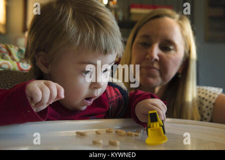 Suwanee, GA, USA. 15th Jan, 2018. Zach Ehlers, 2, has Dpwn syndrome and required eye surgery for cataracts. He has developmental challenges typical of Trisomy 21, the genetic name for the chromosome abnormality. It is a genetic disorder caused by the presence of all or part of a third copy of chromosome and is typically associated with physical growth delays, characteristic facial features and mild to moderate intellectual disability. The average IQ of a young adult with Down syndrome is 50, equivalent to the mental ability of an 8- or 9-year-old child, but this can vary widely.Pictured: Zac Stock Photo