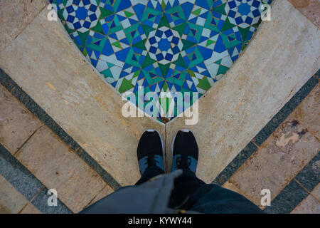 low section of a man standing on moroccan mosaic tile Stock Photo