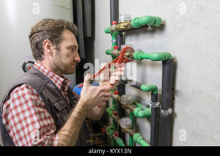 plumber at work installing a water meter Stock Photo