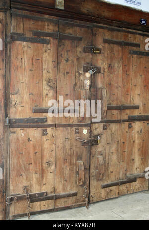 Arabic style art carved door with locks and many hinges, Stone Town, Zanzibar, Tanzania. Stock Photo