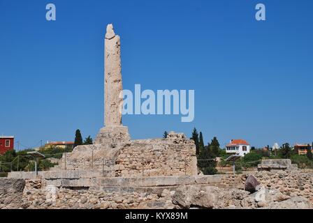 The remaining column of the Temple of Apollo at Aegina Town on the Greek island of Aegina. The ancient acropolis dates from circa 6th century BC. Stock Photo