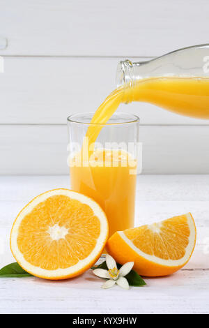 Orange juice pouring pour bottle portrait format oranges fruit fruits drink Stock Photo