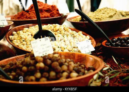 Selection of marinated garlic and olives in food market in provence, France. Stock Photo