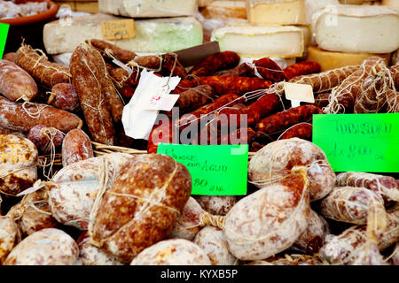 Cured and smoked sausages for sale in Provencal market. Stock Photo