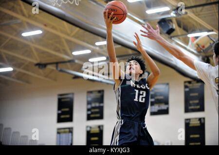 High school player finishing off a drive with an under-handed layup. USA. Stock Photo