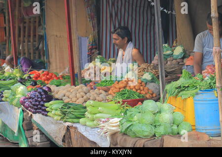 Indian man sells vegetable at street market in Varanasi India. Stock Photo