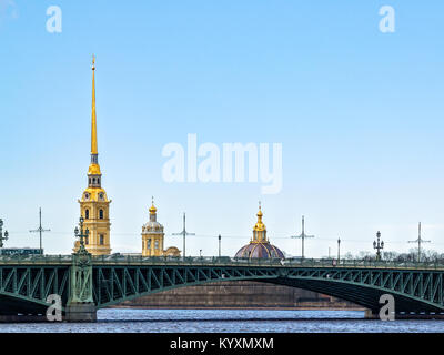 A view of the domes of the churches of the Peter and Paul Fortress over the Troitsky Bridge in the early spring in April on a day in the city of St. P Stock Photo