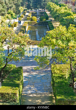 ALCAZAR OF SEVILLE SPAIN  PART OF THE FORMAL GARDENS WITH ORANGE TREES AND RECTANGULAR POOLS VIEWED FROM THE GALERIA DE GRUTESCOS Stock Photo