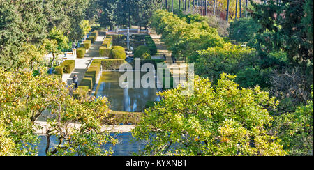 ALCAZAR OF SEVILLE SPAIN VIEW OF PART OF THE FORMAL GARDENS WITH ORANGE TREES AND RECTANGULAR POOLS FROM THE GALERIA DE GRUTESCOS Stock Photo