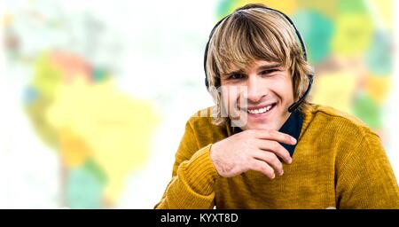 Travel agent man wearing headset in front of world map Stock Photo
