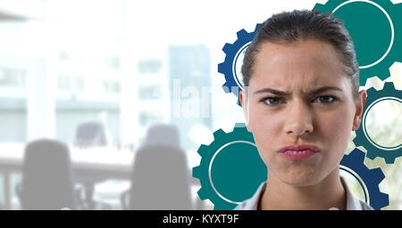 Confused woman in an office with blue cogs Stock Photo