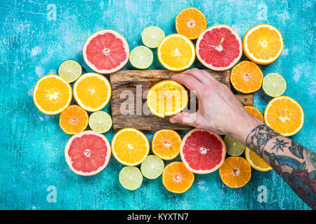 Hand squeezing orange for juice, overhead view. Stock Photo