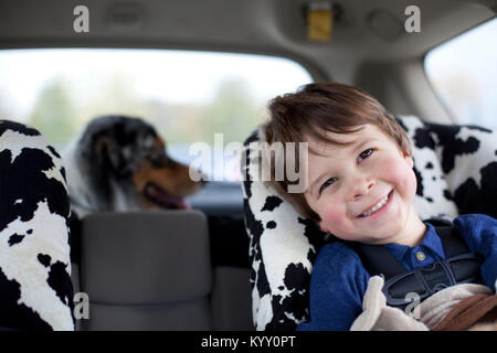Close-up of smiling boy sitting in car Stock Photo