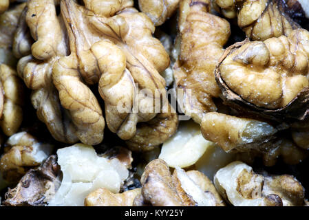 Peeled walnuts on a wooden kitchen desk in a macro closeup with copy space area for health food designs and ideas Stock Photo