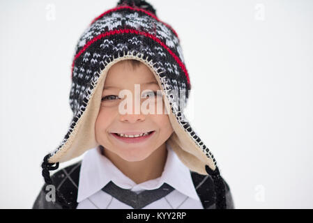 Close-up portrait of smiling boy wearing knit hat during winter Stock Photo