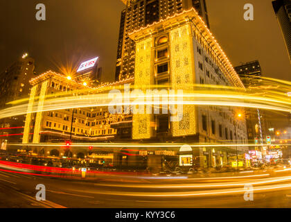 Light trail in front of Peninsula Hotel in Hong Kong during vacation. Stock Photo