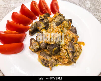 Chicken hearts, stewed with onions and carrots.  Studio Photo Stock Photo