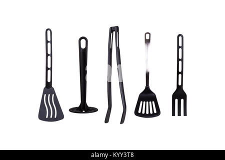 View of black plastic kitchen tools, serving stuff like spatula, tongs, isolated on white background. Stock Photo