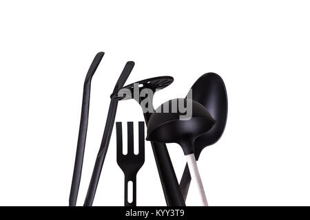 View of black plastic kitchen tools, serving stuff like spatula, tongs, isolated on white background. Stock Photo