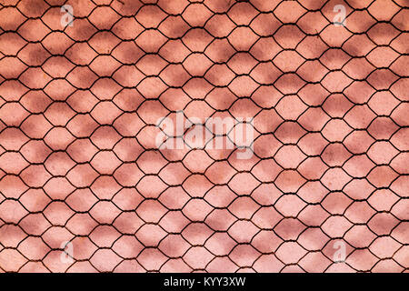 Extreme close up of blurred patterns and textures of rusty double layer hexagonal wire mesh background Stock Photo