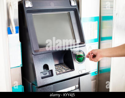 Man using atm machine with his credit card. Stock Photo