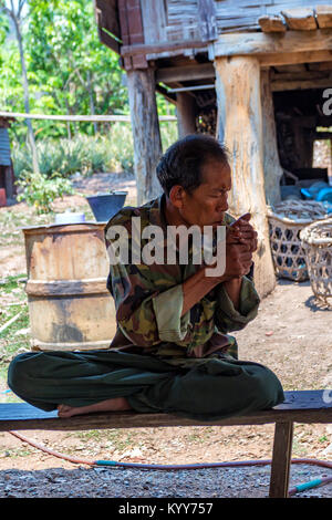 BANGKOK, THAILAND - CIRCA MARCH 2013: Unidentified countryman lights a sigarette Stock Photo
