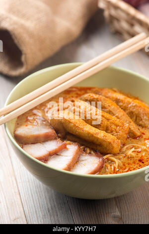 Hot and spicy Singaporean Curry Noodle or laksa mee, serve with chopsticks. Singapore cuisine. Stock Photo