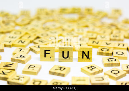 The word fun standing up made from wooden scrabble letters on a white background Stock Photo