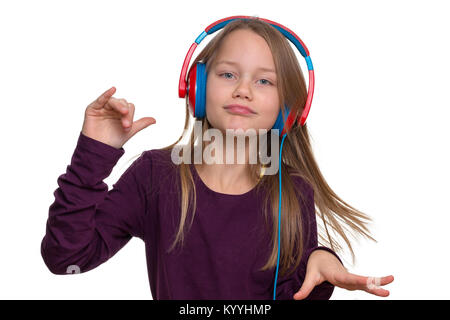 A 9 year old girl listens to music through headphones and dances Stock Photo