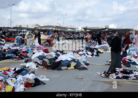 Tunisian women shopping for clothes in Monastir flea market, Monastir, Tunisia Stock Photo