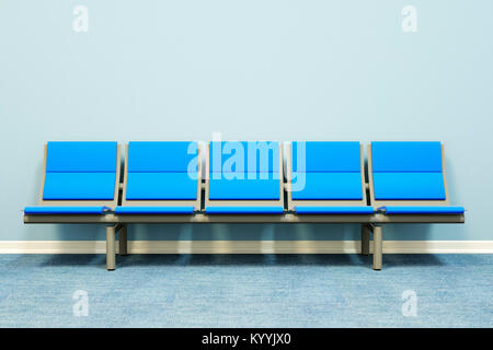 Five seats in a row against a wall in an empty room - waiting room, hospital, doctors, medical, job interview concept Stock Photo