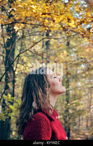 Outdoor portrait of young adult woman with eyes closed Stock Photo