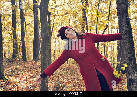 Portrait of happy young woman outdoors in forest Stock Photo