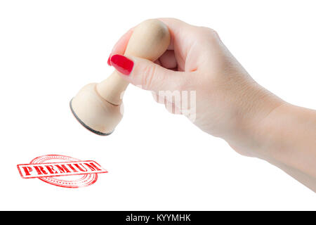 Hand holding a rubber stamp with the word premium isolated on a white background Stock Photo