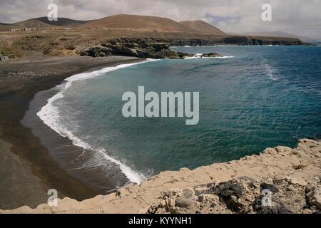 Overview of Playa de los Muertos (Beach of the Dead), a black volcanic sand beach, Ajuy (Peurto de la Pena), Fuerteventura, Canary Islands, May. Stock Photo