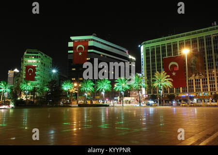 Izmir, Turkey - April 22, 2012: Night view of the square with modern buildings and palms in the city of Izmir, Turkey. Stock Photo