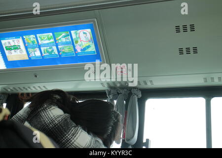 A young female student sleeps on the bus on her way to college in Hangzhou, China. Stock Photo