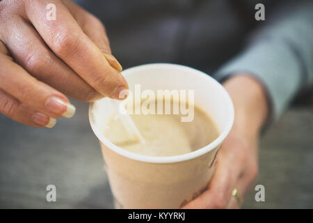 Woman's hands holding disposable coffee cup. Stock Photo