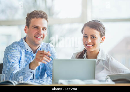 Portrait of young businesspeople using laptop in office Stock Photo