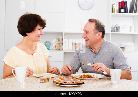 cheerful senior couple having lunch together at home Stock Photo