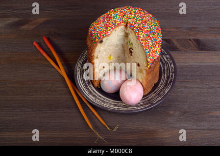 Easter cake, eggs and candles on wooden background top view Stock Photo