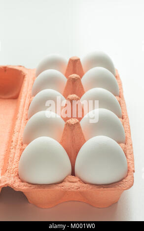 White eggs in the package in white background. Close up. Stock Photo