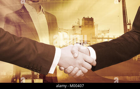 Business handshake on background of construction crane in rays of light Stock Photo