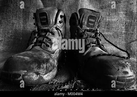 Mens feet with dirty old boots walking into a room Stock Photo - Alamy