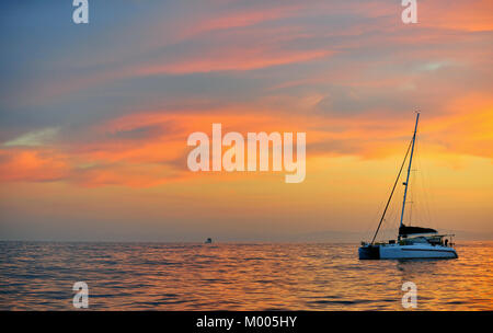 Sailing catamaran at the ocean at the coast of South Africa at early morning. Before sunrise Stock Photo