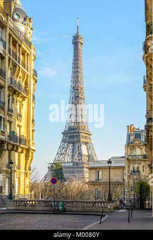 View of the Eiffel Tower from a small cobbled dead-end street of the Chaillot hill by a sunny winter afternoon. Stock Photo